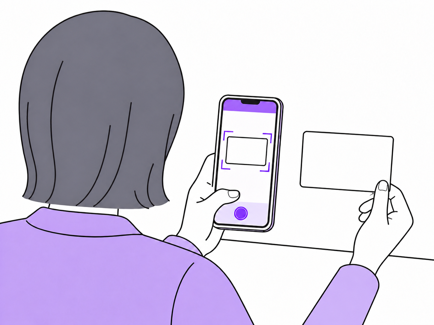 人物がスマートフォンで名刺を撮影して読み取る様子